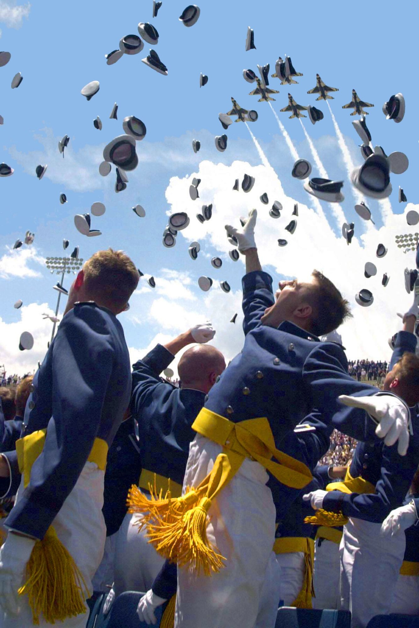 U.S. AIR FORCE ACADEMY, Colo. -- Cadets of the Air Force Academy Class of 2003 celebrate at graduation ceremonies here May 28 as the Air Force Thunderbirds fly overhead.  The 974 students marked the academy's 45th graduating class.  (U.S. Air Force photo by Anna Risse)
