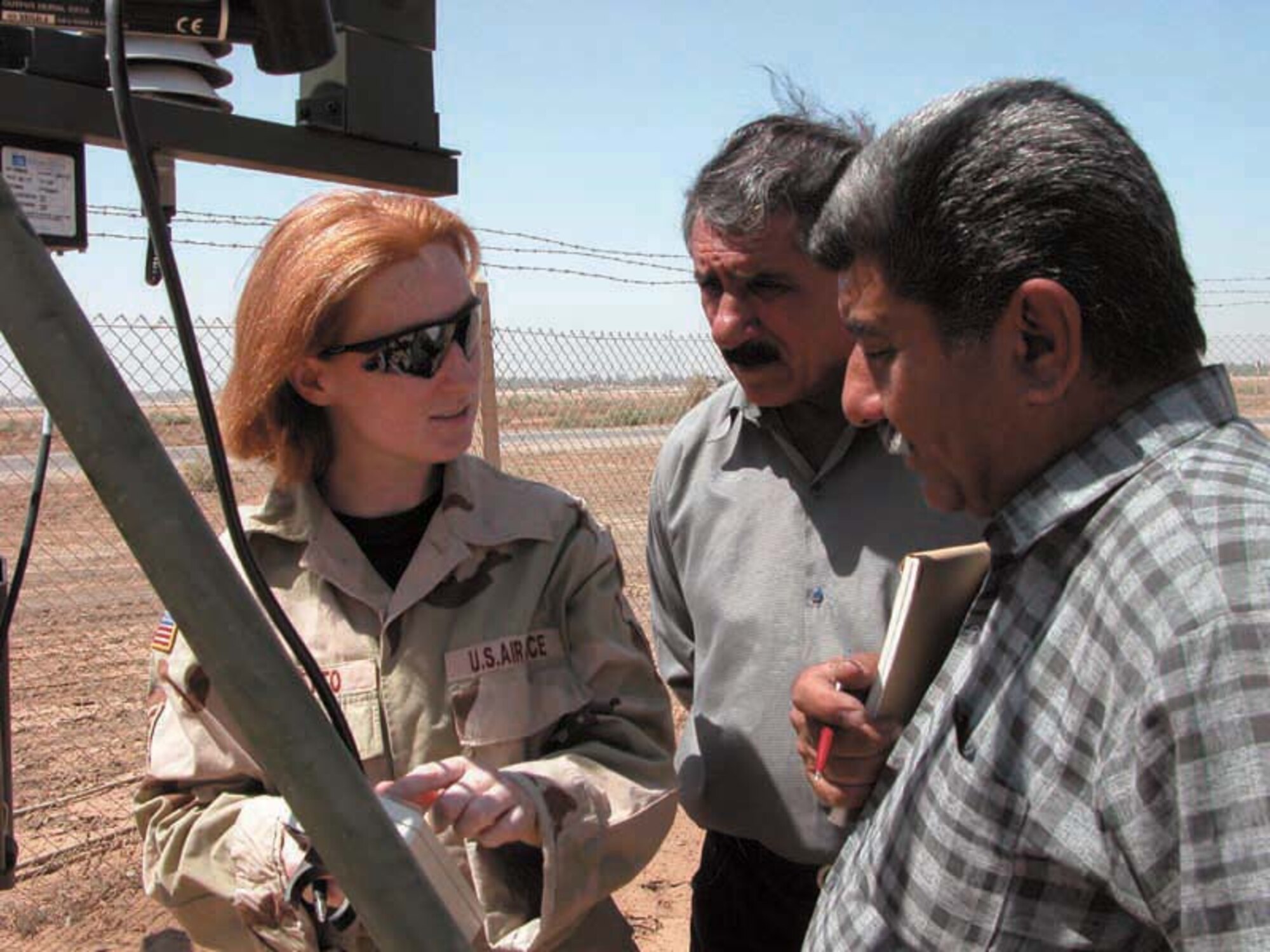 OPERATION IRAQI FREEDOM -- Staff Sgt. Julie Moretto answers questions by members of Iraq's meteorological organization.  Moretto is a 447th Air Expeditionary Group airman deployed to Baghdad from the 15th Air Support Operations Squadron at Hunter Army Air Field, Ga.  (U.S. Air Force photo by 2nd Lt. Rebecca R. Garland)