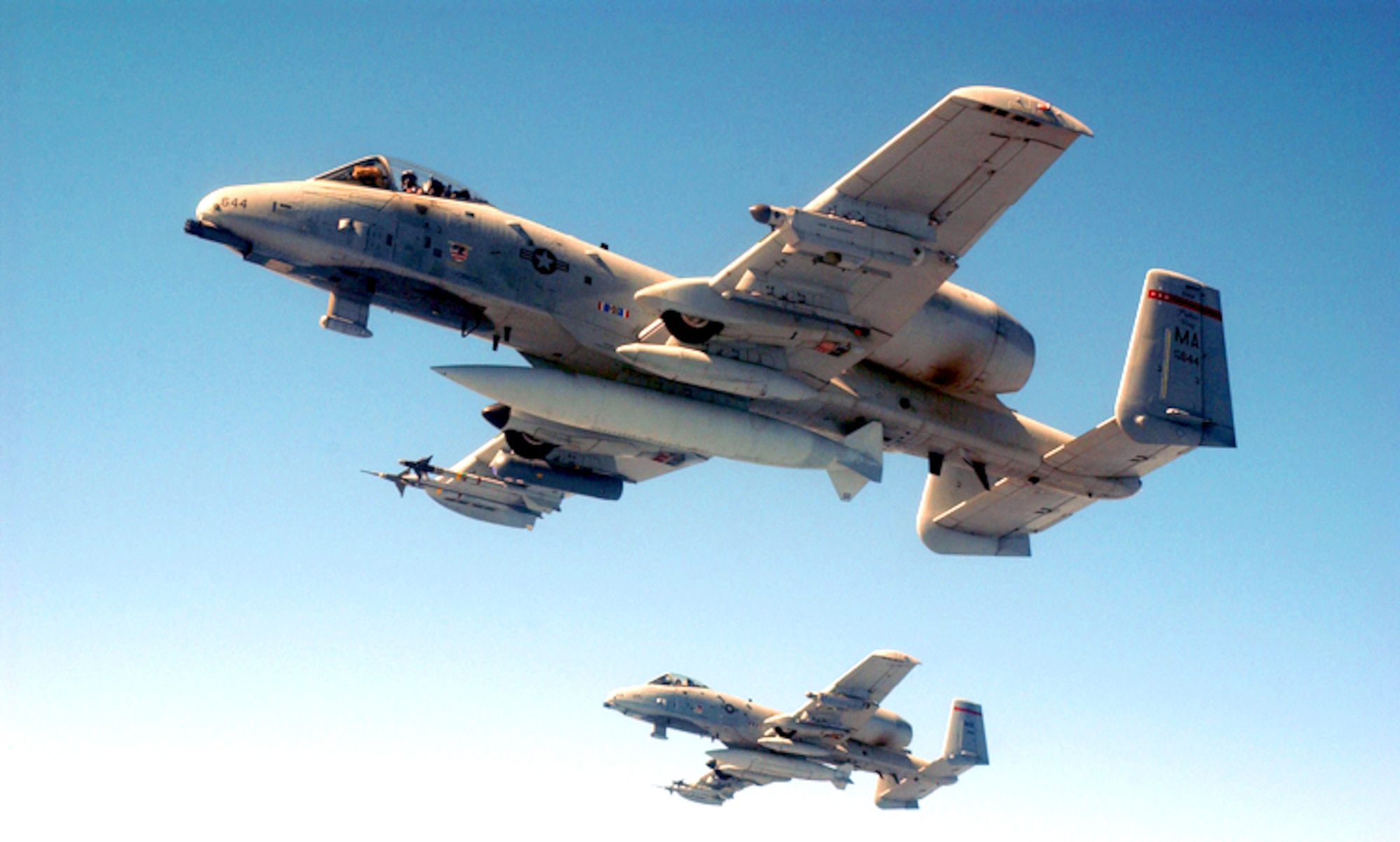 SOUTHWEST ASIA -- A-10 Thunderbolt IIs fly over the desert with LITENING, a precision targeting pod system. The pod, externally mounted to the aircraft, is equipped with a laser designator for precise delivery of laser-guided munitions and a laser rangefinder that provides information for various avionics systems.  (U.S. Air Force photo by Master Sgt. Mark Bucher)