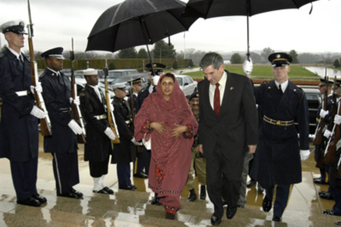 Deputy Secretary of Defense Paul Wolfowitz talks with Pakistani Minister of Education Zubaida Jala Khan as he escorts her into the Pentagon for a meeting on Nov. 11, 2003. 
