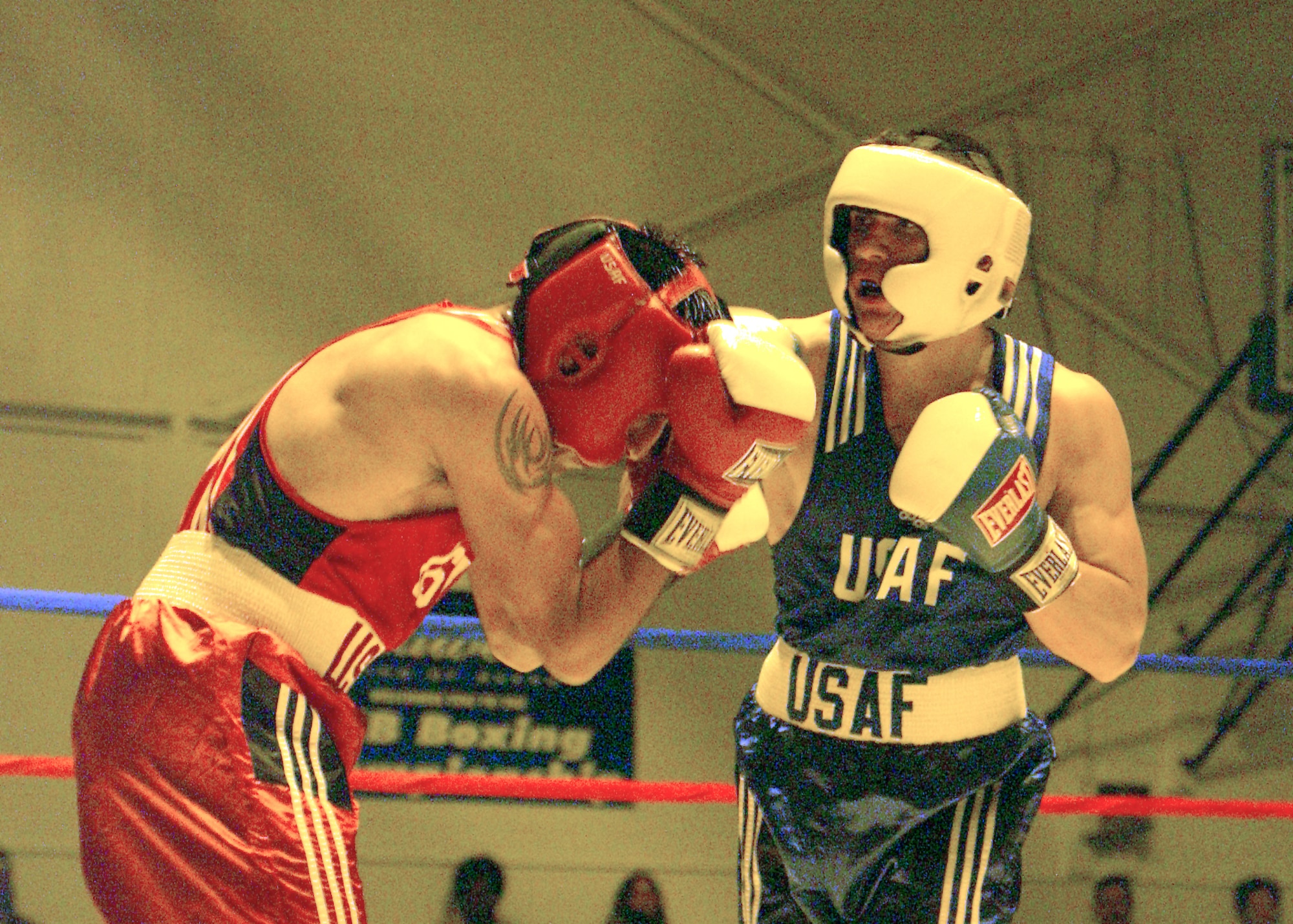 LACKLAND AIR FORCE BASE, Texas -- Airman 1st Class Robert Luna (right) lands a punch on Senior Airman Richard Mora during a light-welterweight bout in the 2004 Air Force Boxing Championships here Nov. 7.  Luna is assigned to the 7th Logistics Readiness Squadron at Dyess Air Force Base, Texas.  Mora is assigned to the 552nd Consolidated Maintenance Squadron at Tinker AFB, Okla.  Luna won the match.  (U.S. Air Force photo by Alan Boedeker)