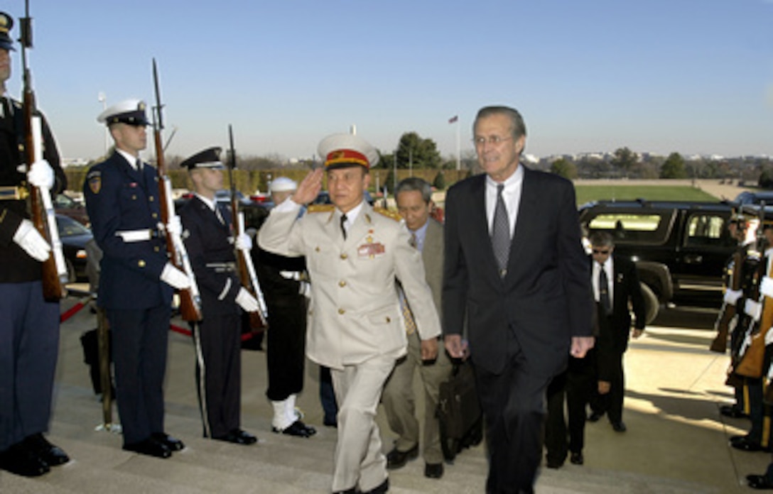 Secretary of Defense Donald H. Rumsfeld escorts Vietnamese Minister of National Defense Senior Gen. Pham Van Tra into the Pentagon on Nov. 10, 2003. The two defense leaders will meet over lunch to discuss a broad range of bilateral and international security issues. 