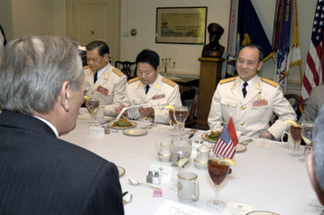 Senior Gen. Pham Van Tra (right), minister of national defense of Vietnam, sits down to a working lunch with Secretary of Defense Donald H. Rumsfeld (foreground) in the Pentagon on Nov. 10, 2003. The two defense leaders planned to discuss a broad range of bilateral and international security issues. Among those participating in the meeting on the Vietnamese side are Lt. Gen. Do Trung Duong (right-center), vice chief of the General Staff, and Lt. Gen. Nguyen Van Chia (left-center), commander of the 7th Military Region. 