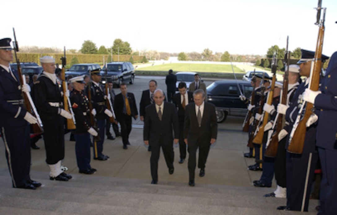 Secretary of Defense Donald H. Rumsfeld talks with Israeli Minister of Defense Shaul Mofaz as he escorts him into the Pentagon for a meeting on Nov. 10, 2003. The two defense leaders will meet to discuss national and international security concerns. 