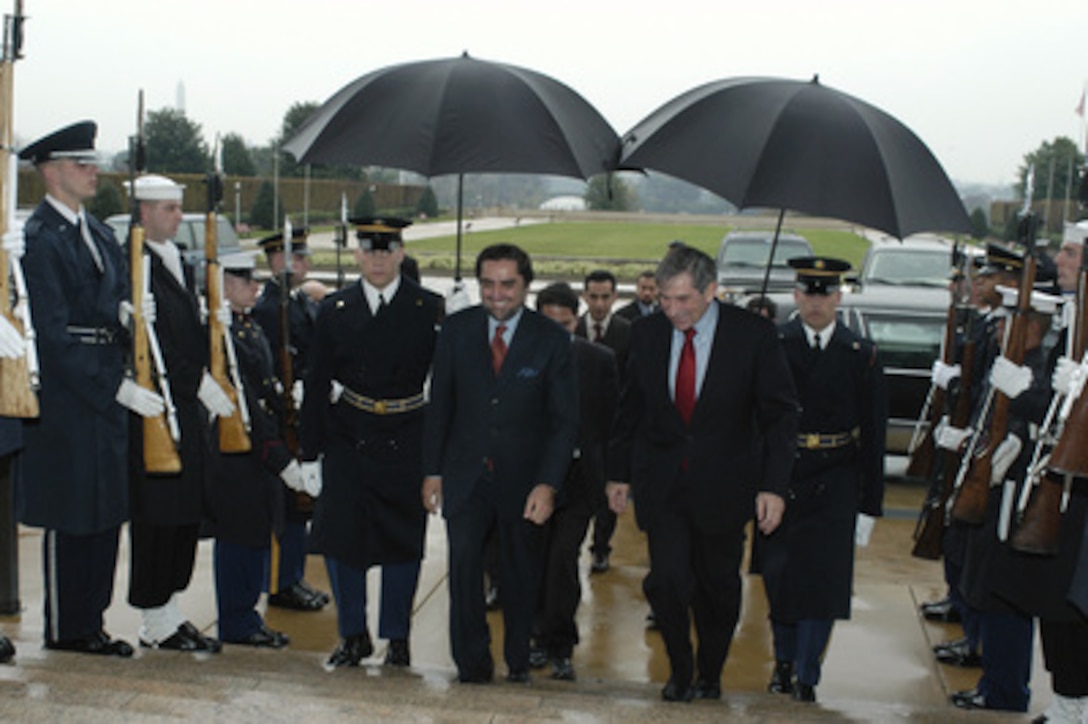 Deputy Secretary of Defense Paul Wolfowitz escorts Afghanistan's Minister of Foreign Affairs Abdullah Abdullah (left) into the Pentagon on Nov. 12, 2003. The two leaders will meet to discuss defense issues of mutual interest. 