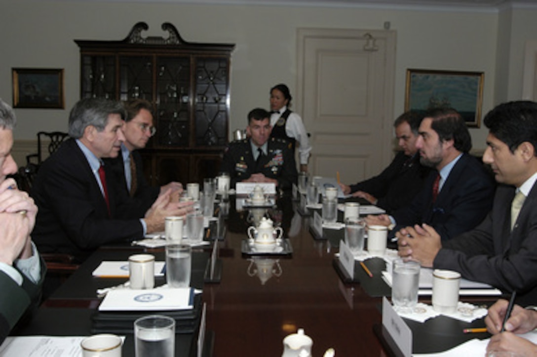 Deputy Secretary of Defense Paul Wolfowitz (left) and his staff meet with Afghanistan's Minister of Foreign Affairs Abdullah Abdullah in the Pentagon on Nov. 12, 2003. From left to right: Wolfowitz; Principal Deputy Assistant Secretary of Defense for International Security Affairs Peter Flory; Maj. Gen. William Caldwell, U.S. Army, senior military assistant to Wolfowitz; Gen. Payenda, Afghanistan's defense attaché; Abdullah; Omar Samad, spokesman, Afghan Ministry of Foreign Affairs. 