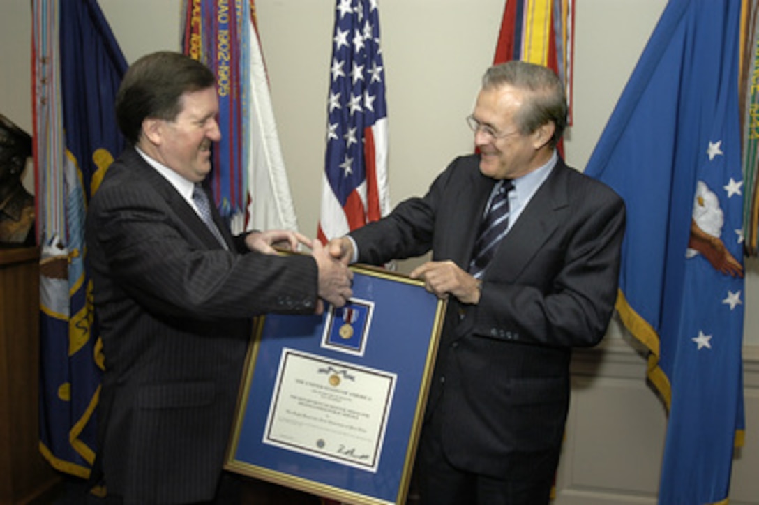 Secretary of Defense Donald H. Rumsfeld (right) presents the Department of Defense Distinguished Public Service Award to NATO Secretary General Lord George Robertson (left) in the Pentagon on Nov. 12, 2003. Robertson was recognized for his legacy of accomplishment as the secretary general of the North Atlantic Treaty Organization since October 1999. Robertson will be stepping down from the post next month. 