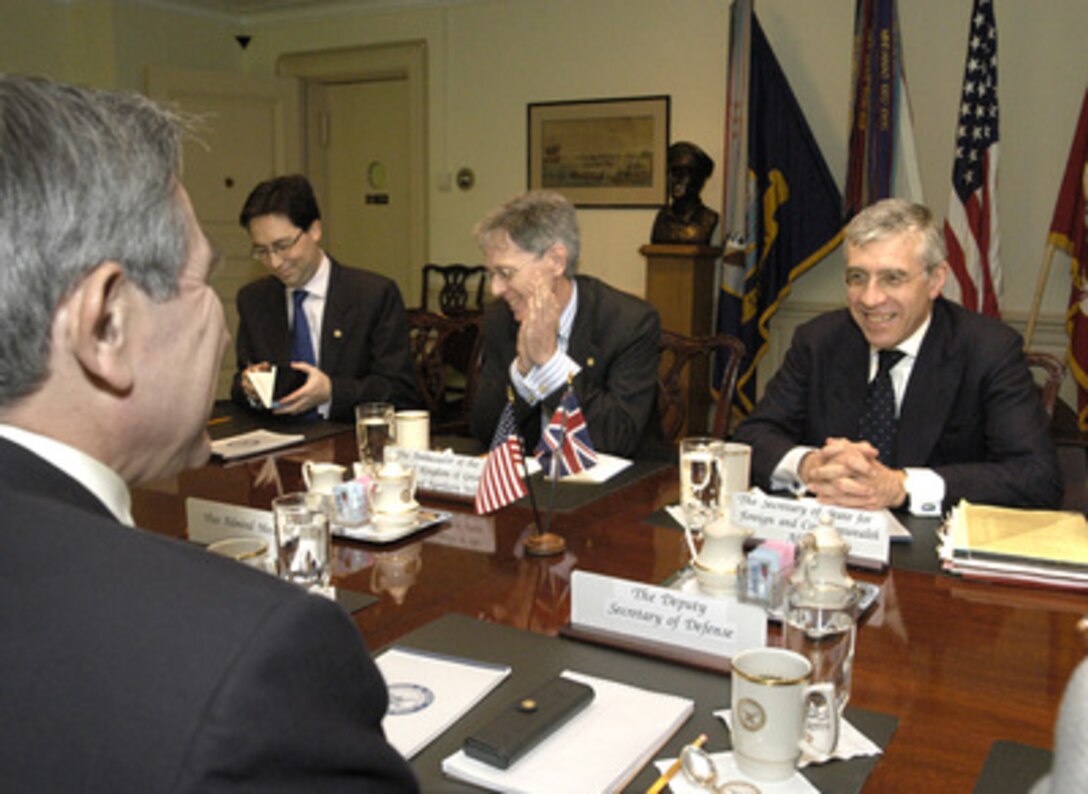Secretary of State for Foreign and Commonwealth Affairs Jack Straw (right), of the United Kingdom, meets with Deputy Secretary of Defense Paul Wolfowitz (foreground) in the Pentagon on Nov. 13, 2003. Under discussion is a range of issues relating to the international coalition's efforts to bring stability and democracy to Iraq. Also participating in the meeting are Ambassador Sir David Manning (center) and Jonathan Sinclair, the note taker. 