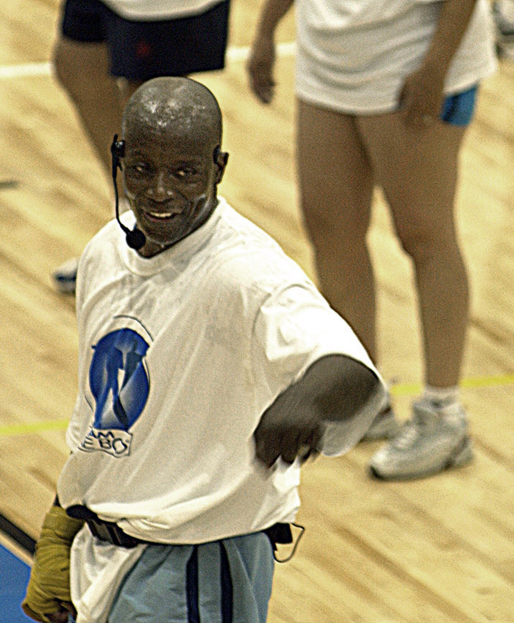 LANGLEY AIR FORCE BASE, Va. -- Tae Bo creator Billy Blanks stretches out with a gym full of students on opening night of Langley's new fitness center Nov. 7.  Blanks led the class of more than 500 in his unique mix of dance, aerobic and Tae Kwon Do moves.  (U.S. Air Force photo by Airman Samantha Willner)