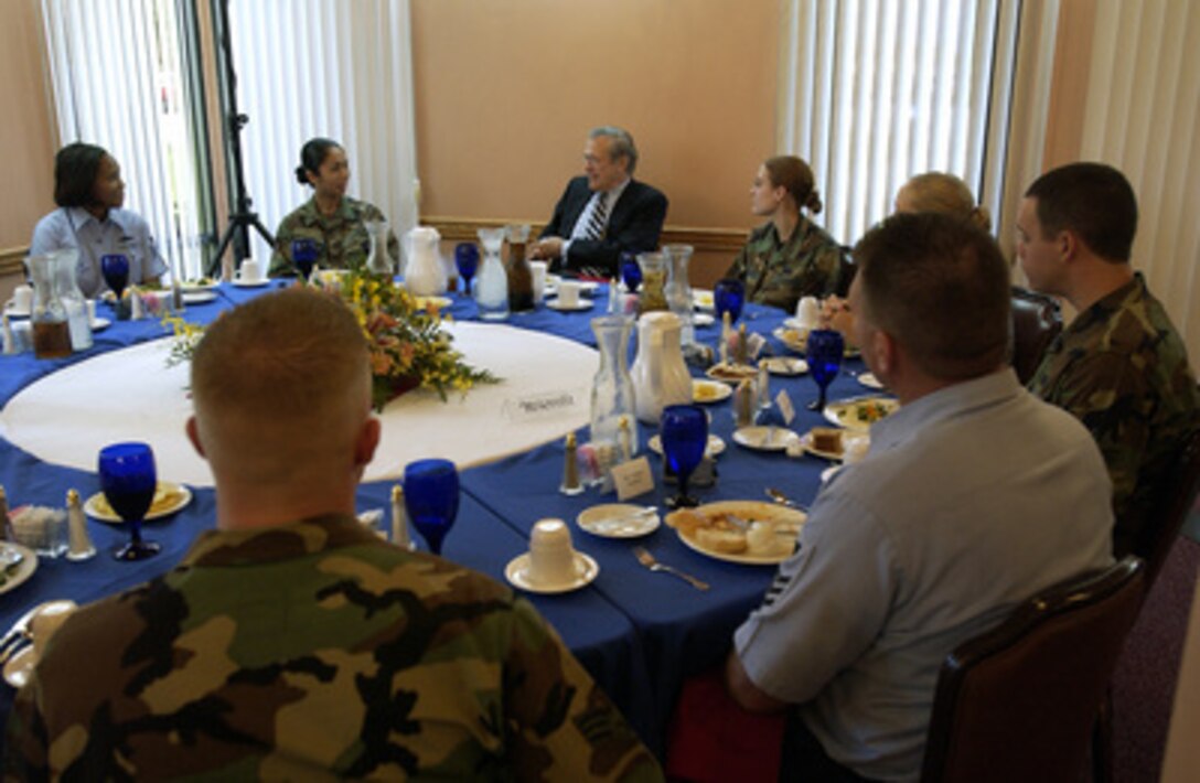 Secretary of Defense Donald H. Rumsfeld talks with U.S. service men and women during lunch at the Magellan Hall dining facility at Andersen Air Force Base, Guam, on Nov. 14, 2003. Rumsfeld used the stop in Guam as opportunity to speak with the troops in a town hall meeting and to meet local commanders and officials. Rumsfeld will travel to Japan and South Korea to meet with U.S. military forces and the local military and civilian leadership. 
