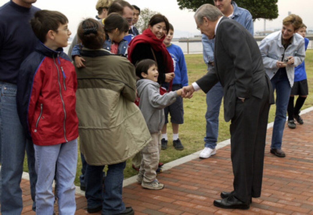 Secretary of Defense Donald H. Rumsfeld shakes hands with family members from Yokosuka Naval Base, Japan, on Nov. 15, 2003. Rumsfeld is traveling to Guam, Japan and South Korea to meet with U.S. military forces and the local military and civilian leadership. 