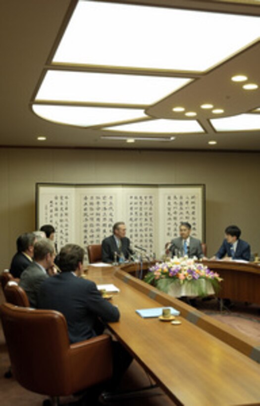 Secretary of Defense Donald H. Rumsfeld listens to the interpreter during his talks with Okinawa Governor Keiishi Inamine in his office at Naha, Okinawa, on Nov. 16, 2003. Rumsfeld is traveling to Guam, Japan and South Korea to meet with U.S. military forces and the local military and civilian leadership. 