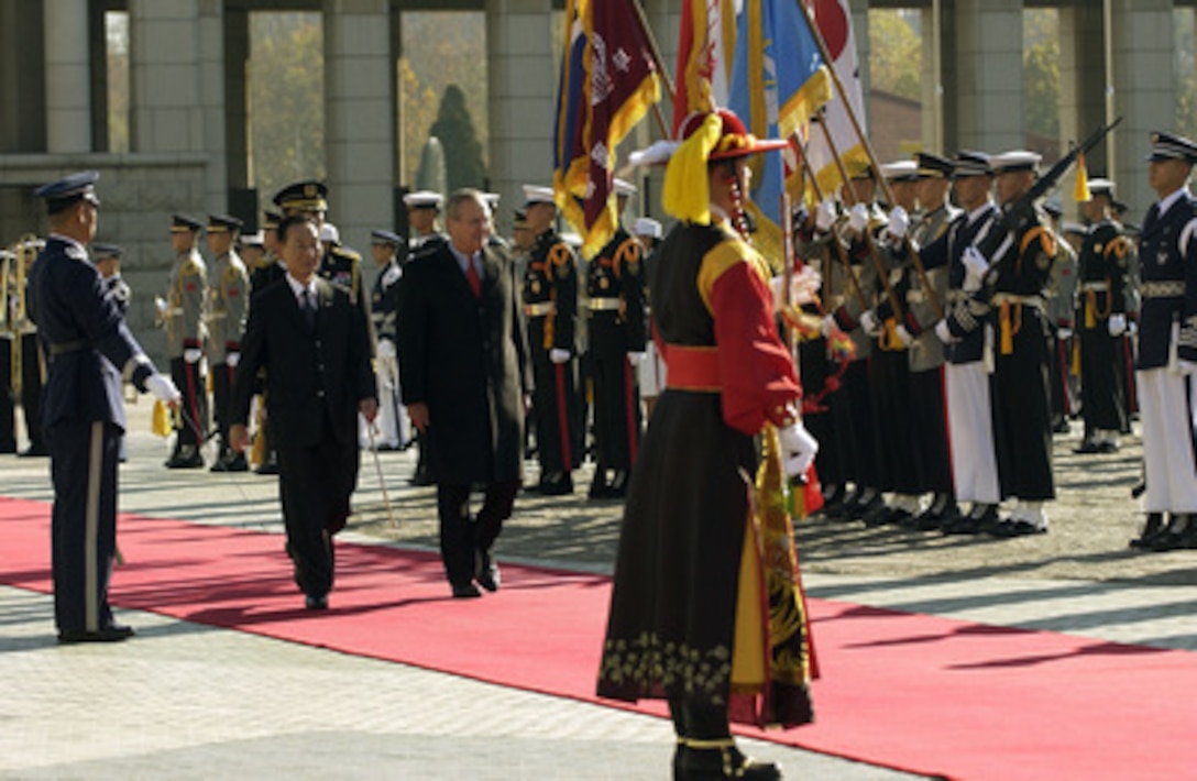 Secretary of Defense Donald H. Rumsfeld (center) is escorted by South Korean Minister of National Defense Cho Yong-kil as they review the troops at the National War Museum in Seoul, South Korea, on Nov. 17, 2003. Rumsfeld is traveling to Guam, Japan and South Korea to meet with U.S. military forces and the local military and civilian leadership. 