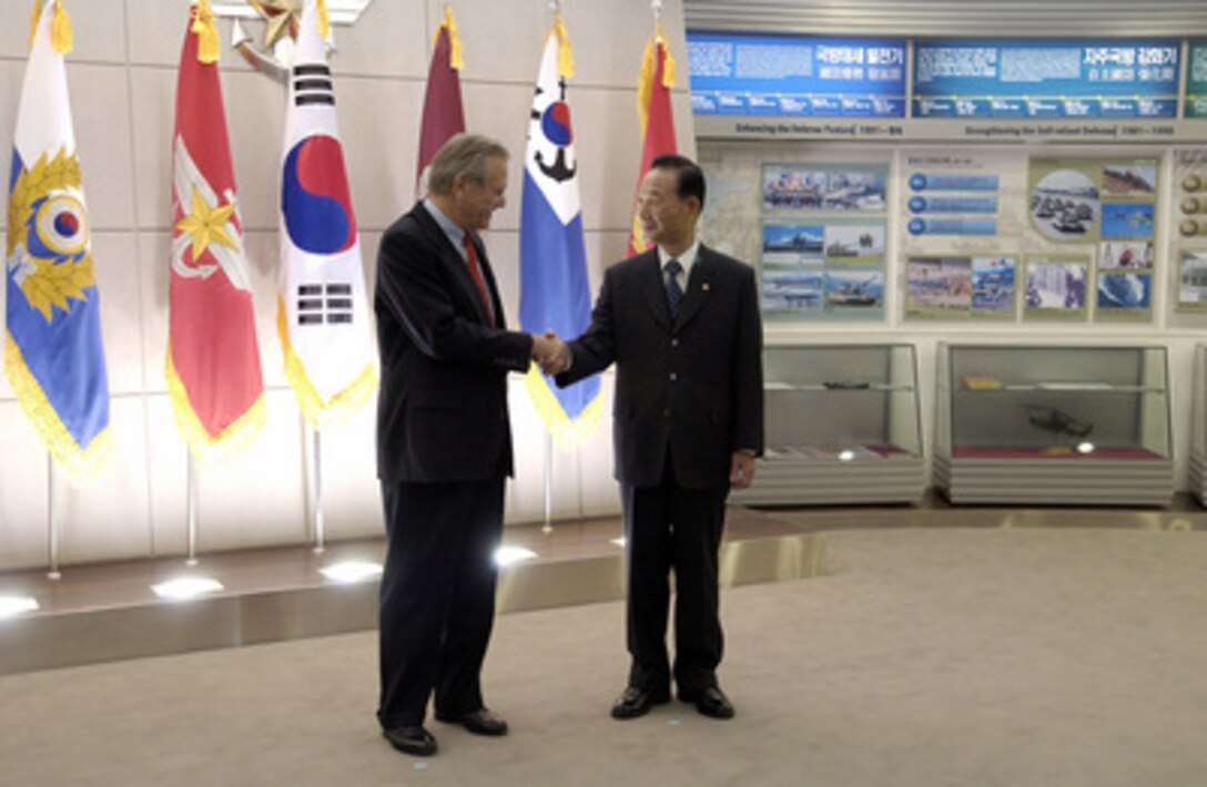 Secretary of Defense Donald H. Rumsfeld (left) shakes hands with South Korean Minister of National Defense Cho Yong-kil in the National War Museum in Seoul, South Korea, on Nov. 17, 2003. Rumsfeld is traveling to Guam, Japan and South Korea to meet with U.S. military forces and the local military and civilian leadership. 