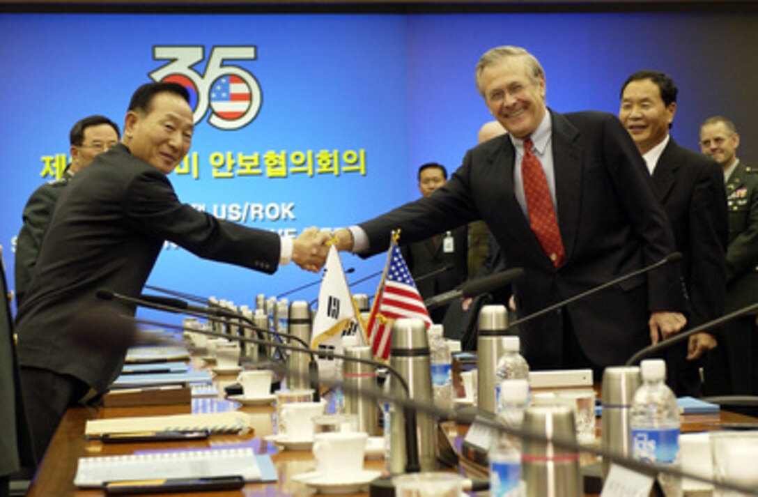 Secretary of Defense Donald H. Rumsfeld (right) and South Korean Minister of National Defense Cho Yong-kil shake hands for the photographers at the beginning of the annual Security Consultative Meeting at the National War Museum in Seoul, South Korea, on Nov. 17, 2003. Rumsfeld is traveling to Guam, Japan and South Korea to meet with U.S. military forces and the local military and civilian leadership. 