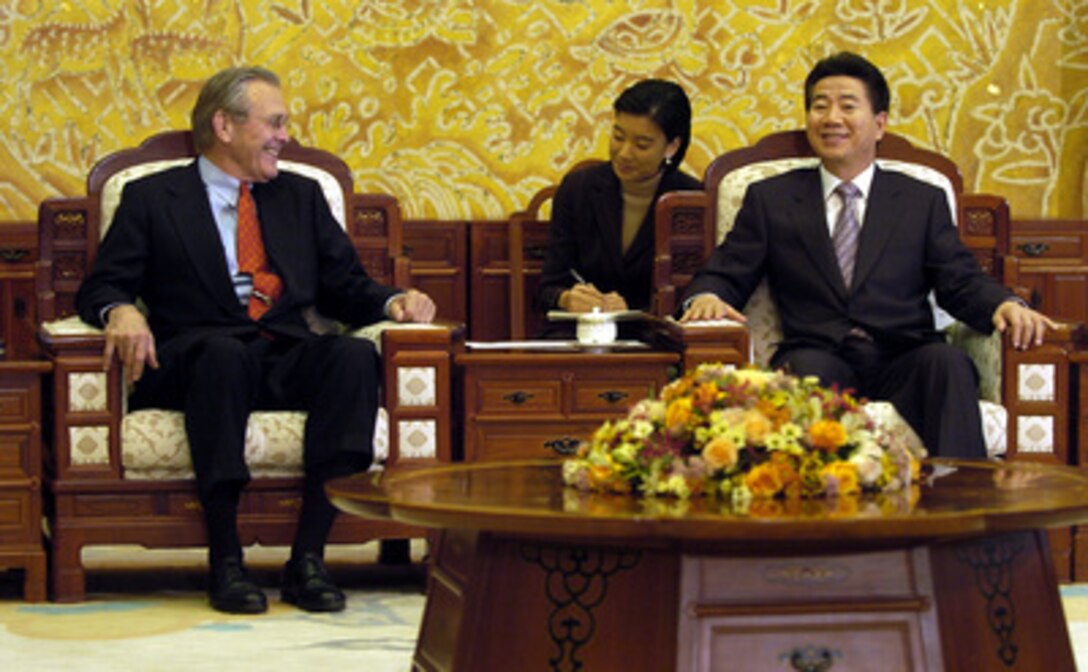 Secretary of Defense Donald H. Rumsfeld shares a lighter moment with South Korean President Roh Moo-hyun at the Blue House in Seoul, South Korea, on Nov. 17, 2003. Rumsfeld is traveling to Guam, Japan and South Korea to meet with U.S. military forces and the local military and civilian leadership. 