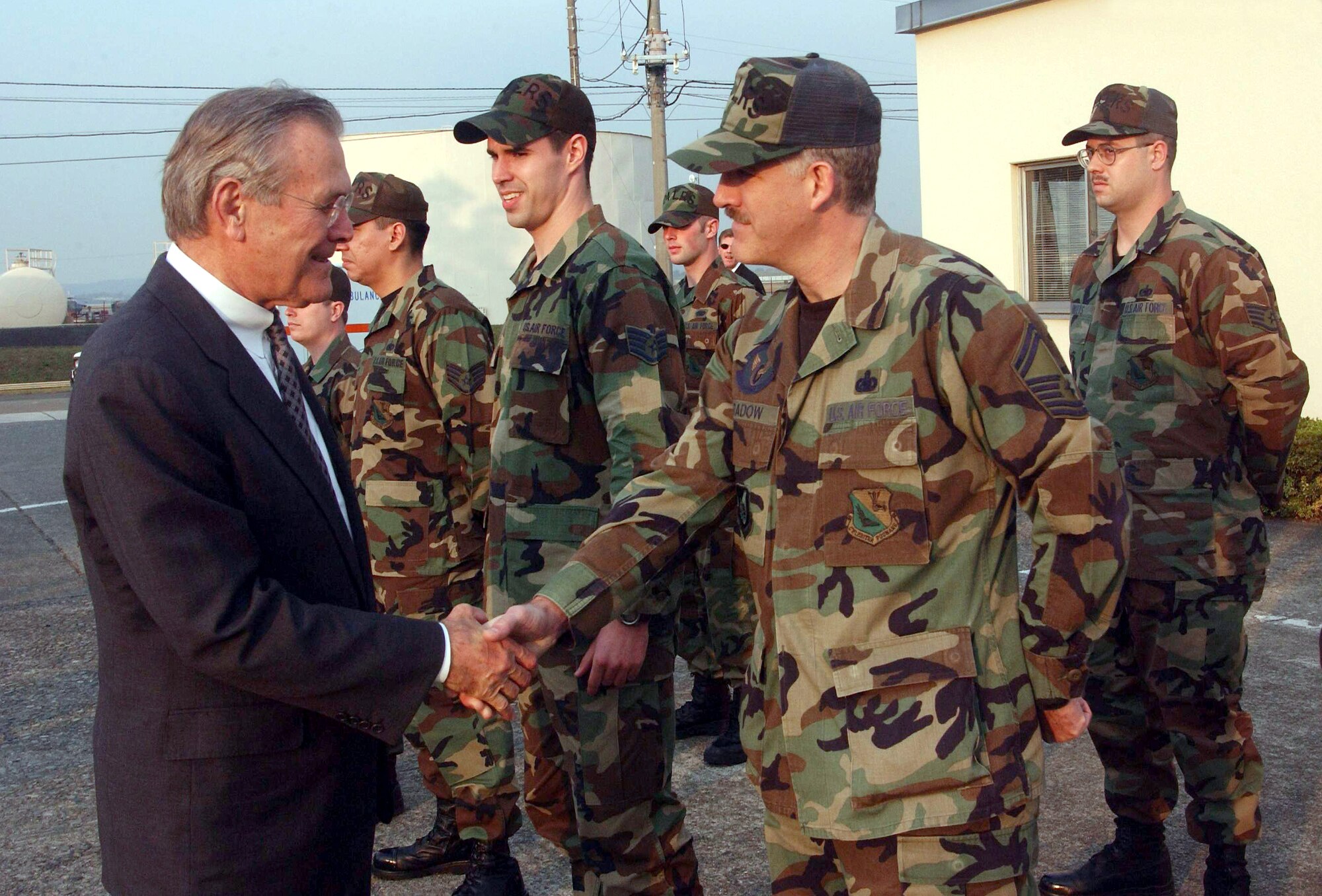 YOKOTA AIR BASE, Japan -- Secretary of Defense Donald H. Rumsfeld shakes hand with Senior Master Sgt. Michael Bradow during his visit here Nov. 15.  Rumsfeld met with airmen during a two-day visit in Japan which included stops at military bases in Tokyo and Okinawa.  Bradow is assigned to the 374th Logistics Readiness Squadron.  (U.S. Air Force photo by Master Sgt. Val Gempis)