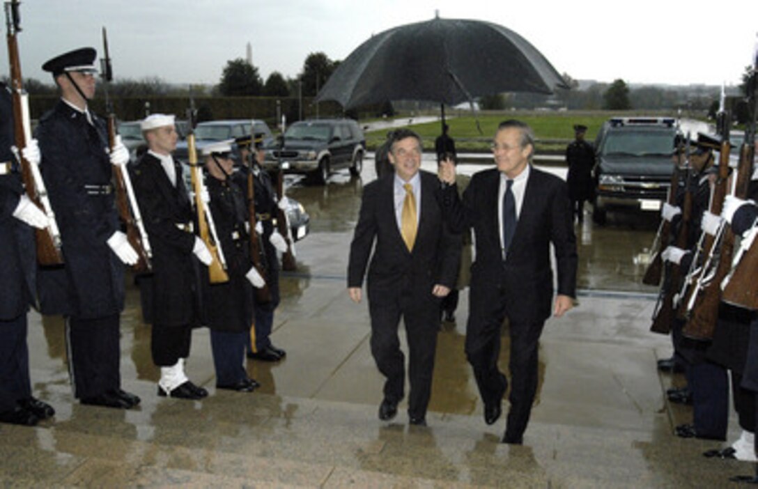 Secretary of Defense Donald H. Rumsfeld (right) escorts Australian Minister for Defense Robert Hill into the Pentagon on Nov. 19, 2003. The two defense leaders will meet to discuss a range of bilateral and international security issues. 