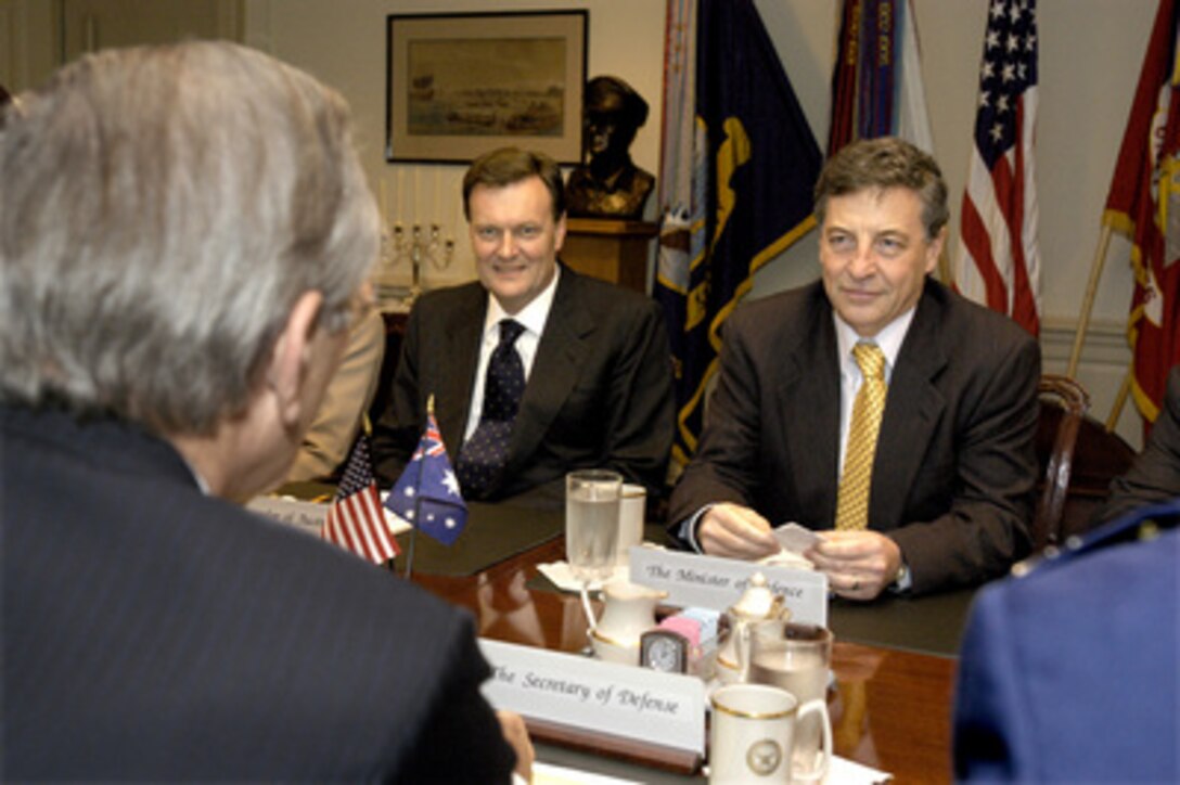 Australian Minister for Defense Robert M. Hill (right) meets with Secretary of Defense Donald H. Rumsfeld in the Pentagon on Nov. 19, 2003. Under discussion is a broad range of bilateral and international security issues. Also participating in the talks is Australia's Ambassador to the United States Michael Thawley (center). 