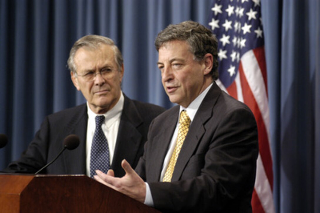 Australia's Minister for Defense Robert M. Hill (right) responds to a reporter's question during a joint media availability with Secretary of Defense Donald H. Rumsfeld (left) in the Pentagon on Nov. 19, 2003. 