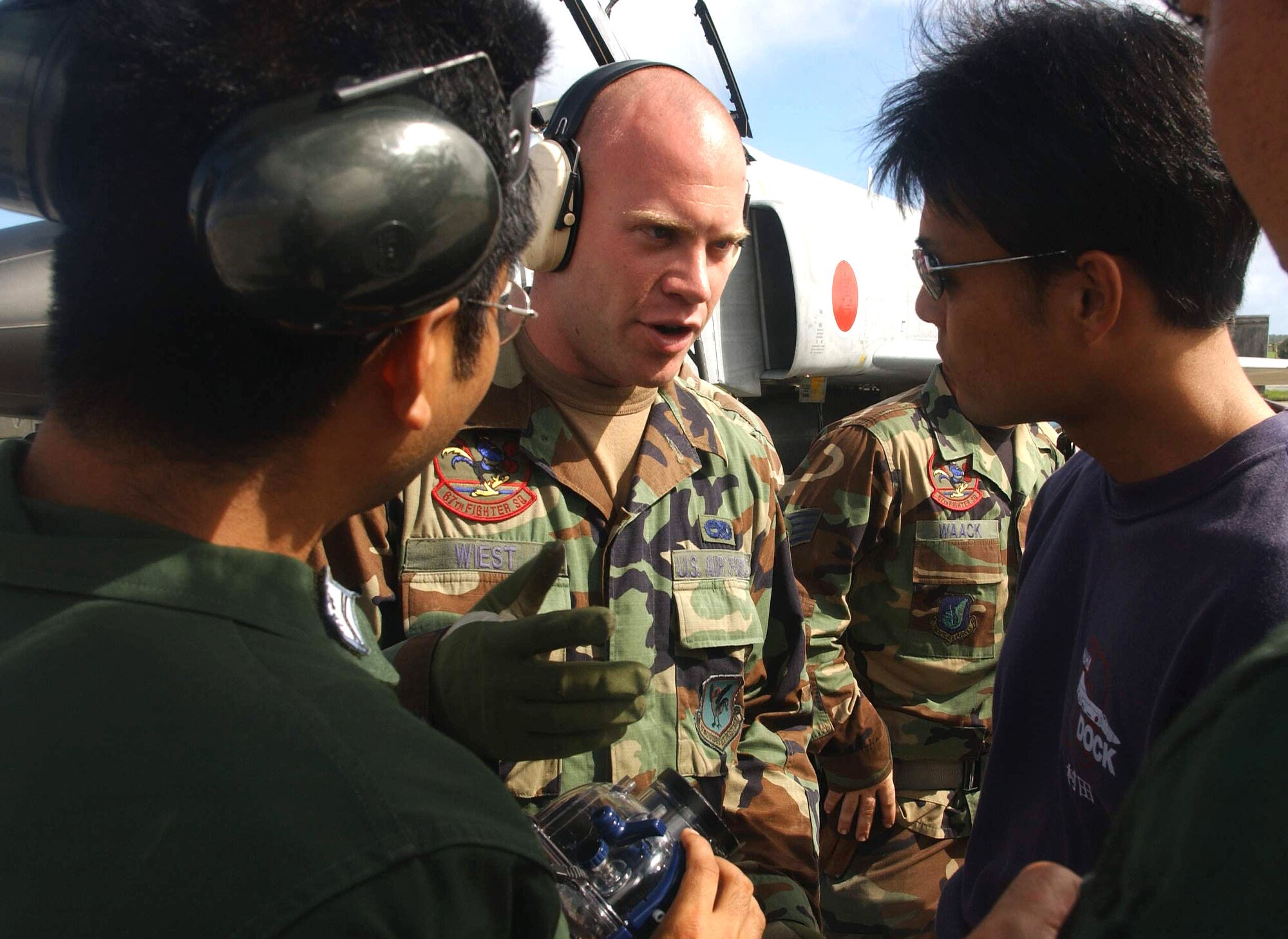 ANDERSEN AIR FORCE BASE, Guam -- Staff Sgt. Michael Wiest conducts familiarization training here with Japanese F-4 crew chiefs from the 83rd Wing at Naha Air Base, Japan, during exercise Cope North.  Wiest is a crew chief from the 67th Aircraft Maintenance Unit at Kadena Air Base, Japan.  (U.S. Air Force photo by Master Sgt. Val Gempis)