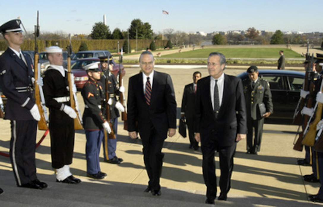 Secretary of Defense Donald H. Rumsfeld (right) escorts Nicaraguan Minister of Defense Jose Guerra (left) through an honor cordon and into the Pentagon on Nov. 20, 2003. Guerra will meet with Rumsfeld, Chairman of the Joint Chiefs of Staff Gen. Richard B. Myers and other senior Department of Defense officials to discuss a range of regional and global security issues. 