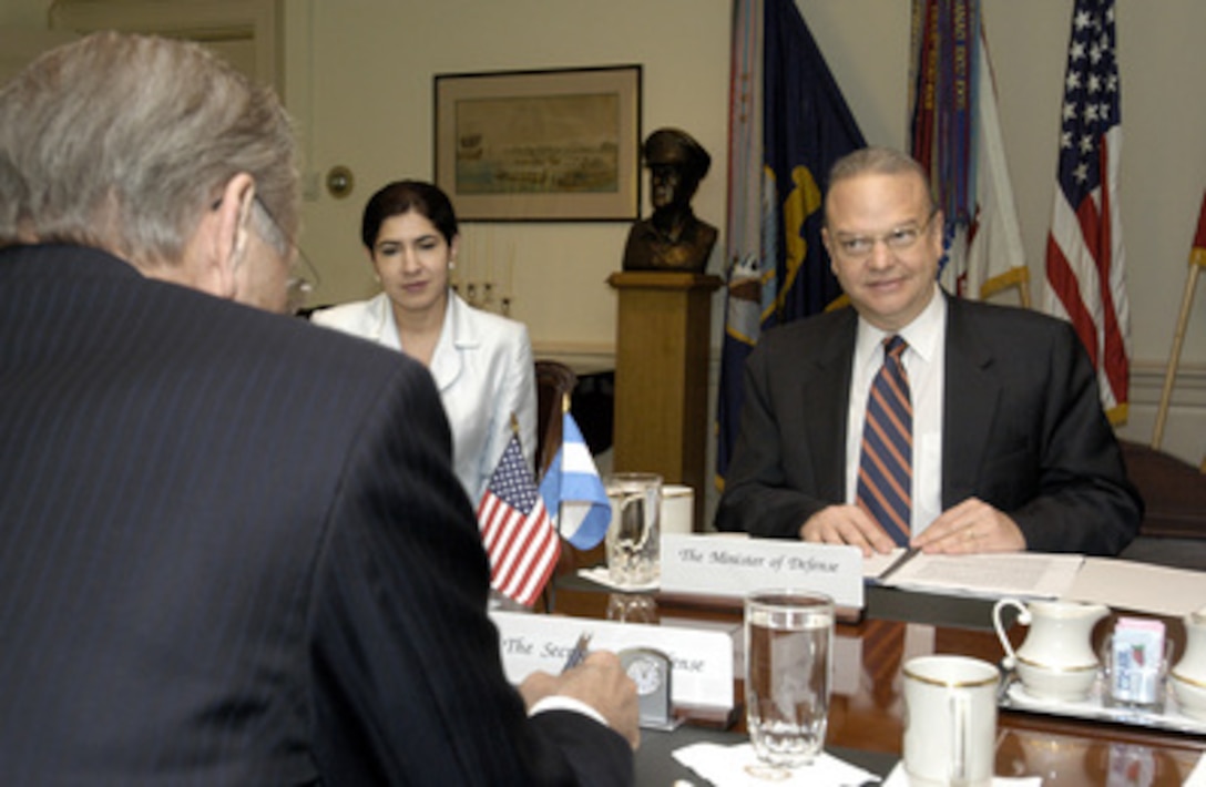 Minister of Defense Jose Guerra (right), of Nicaragua, meets with Secretary of Defense Donald H. Rumsfeld (foreground) in the Pentagon on Nov. 20, 2003. A range of security issues of mutual interest to both nations were on the table for discussion. Carmen Gutierrez (center), the Charge' at the Nicaraguan Embassy in Washington, D.C., joined Guerra for the meeting. 