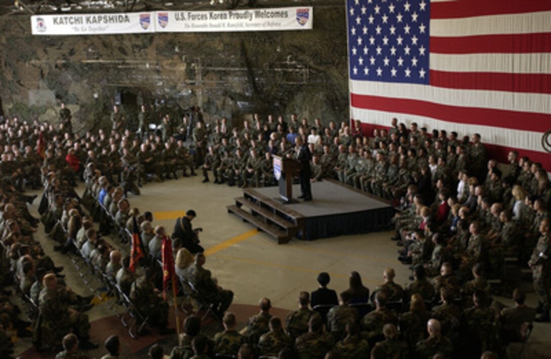 Secretary of Defense Donald H. Rumsfeld is surrounded by U.S. troops during a town hall meeting at Osan Air Base, South Korea, on Nov. 18, 2003. Rumsfeld is traveling to Guam, Japan, and South Korea to meet with U.S. military forces and the local military and civilian leadership. 
