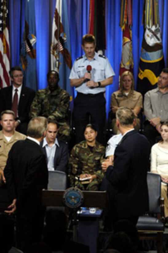 Secretary of Defense Donald H. Rumsfeld and Chairman of the Joint Chiefs of Staff General Richard B. Myers, USAF, listen to a question from Lt. Col. Ernest Weeks during a Pentagon town hall meeting on Nov. 21, 2003. 