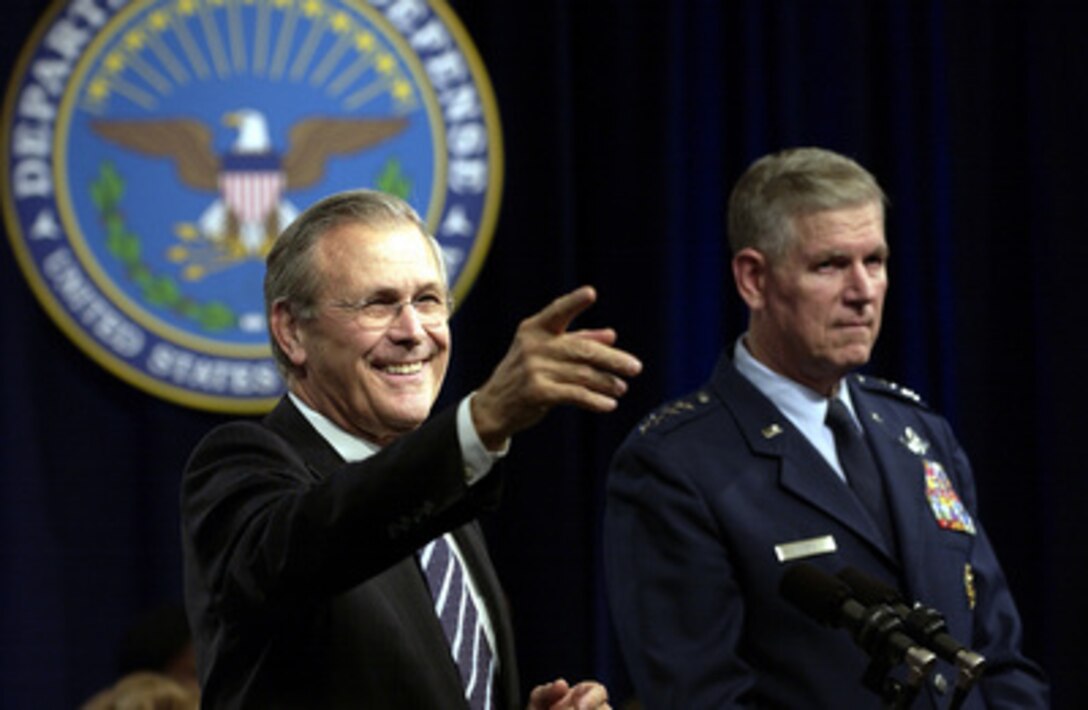 Secretary of Defense Donald H. Rumsfeld calls on a member of the audience at a town hall meeting in the Pentagon auditorium on Nov. 21, 2003. Rumsfeld and Chairman of the Joint Chiefs of Staff Gen. Richard B. Myers, U.S. Air Force, delivered opening remarks then fielded questions from military and civilian Pentagon employees. The forum allows people in the Pentagon to direct their questions to the leadership of the Defense Department. 