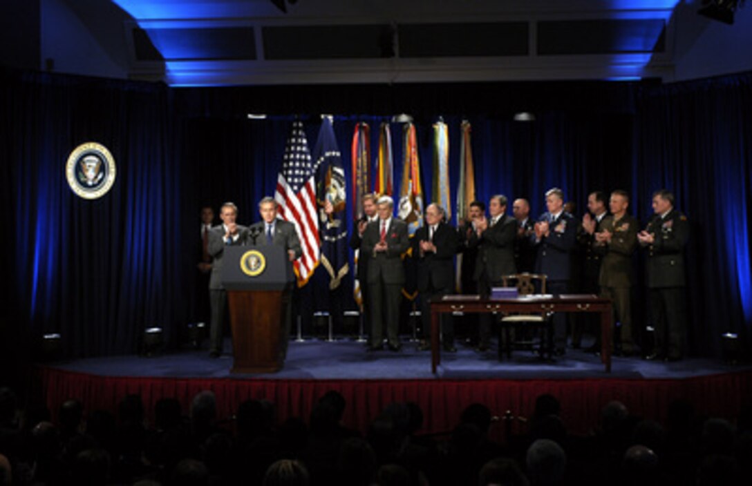 President George W. Bush receives a round of applause during his remarks prior to signing the National Defense Authorization Act at the Pentagon on Nov. 24, 2003. The Act provides $401.3 billion for the Department of Defense, which will allow for continued support of the missions of the U.S. Military and its men and women serving around the globe. 