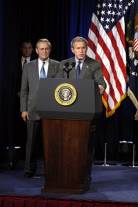 Secretary of Defense Donald H. Rumsfeld listens while President George W. Bush speaks prior to signing the National Defense Authorization Act at the Pentagon on Nov. 24, 2003. The Act provides $401.3 billion for the Department of Defense, which will allow for continued support of the missions of the U.S. Military and its men and women serving around the globe. 