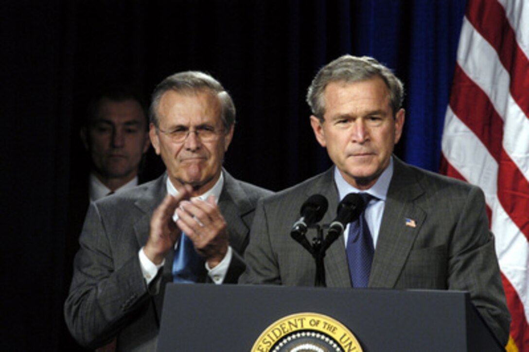 Secretary of Defense Donald H. Rumsfeld applauds President George W. Bush during his remarks prior to signing the National Defense Authorization Act at the Pentagon on Nov. 24, 2003. The Act provides $401.3 billion for the Department of Defense, which will allow for continued support of the missions of the U.S. Military and its men and women serving around the globe. 