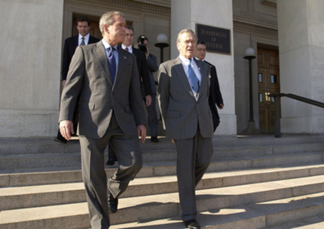 Secretary of Defense Donald H. Rumsfeld escorts President George W. Bush to his helicopter at the Pentagon on Nov. 24, 2003. Bush earlier signed the National Defense Authorization Act providing $401.3 billion for the Department of Defense, which will allow for continued support of the missions of the U.S. Military and its men and women serving around the globe. 