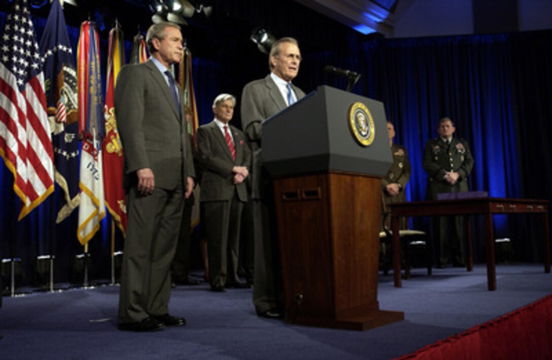 Secretary of Defense Donald H. Rumsfeld introduces President George W. Bush to the audience in the Pentagon on Nov. 24, 2003. Bush is at the Pentagon to sign the National Defense Authorization Act. The Act provides $401.3 billion for the Department of Defense, which will allow for continued support of the missions of the U.S. Military and its men and women serving around the globe. 