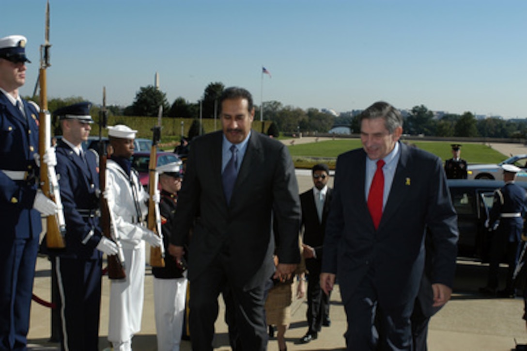Deputy Secretary of Defense Paul Wolfowitz escorts the First Deputy Prime Minister of Qatar Shaikh Hamad bin Jasim bin Jabir Al Thani into the Pentagon on Sept. 30, 2003. The two leaders are meeting to discuss defense issues of mutual interest. 