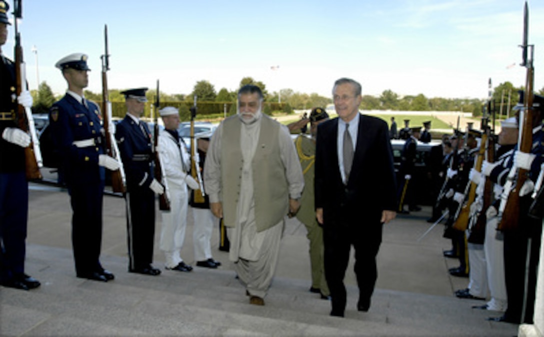 Secretary of Defense Donald H. Rumsfeld escorts Pakistani Prime Minister Mir Zafarullah Khan Jamali into the Pentagon on Oct. 3, 2003. Rumsfeld and the Prime Minister will meet to discuss a broad range of bilateral security issues. 