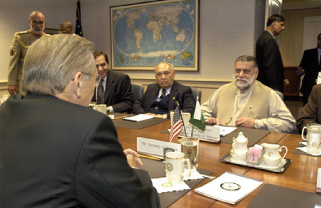 Pakistani Prime Minister Mir Zafarullah Khan Jamali (right) meets with Secretary of Defense Donald H. Rumsfeld (left foreground) at the Pentagon on Oct. 3, 2003. Under discussion is a broad range of bilateral security issues, many relating to the global war on terrorism, in which Pakistan is playing a significant role. Among others participating in the talks, on the Pakistani side, are Minister of Foreign Affairs Khurshid M. Kasuri (center) and Honorary Advisor to the Prime Minister Syed Sharifuddin Pirzada (seated at the left). 