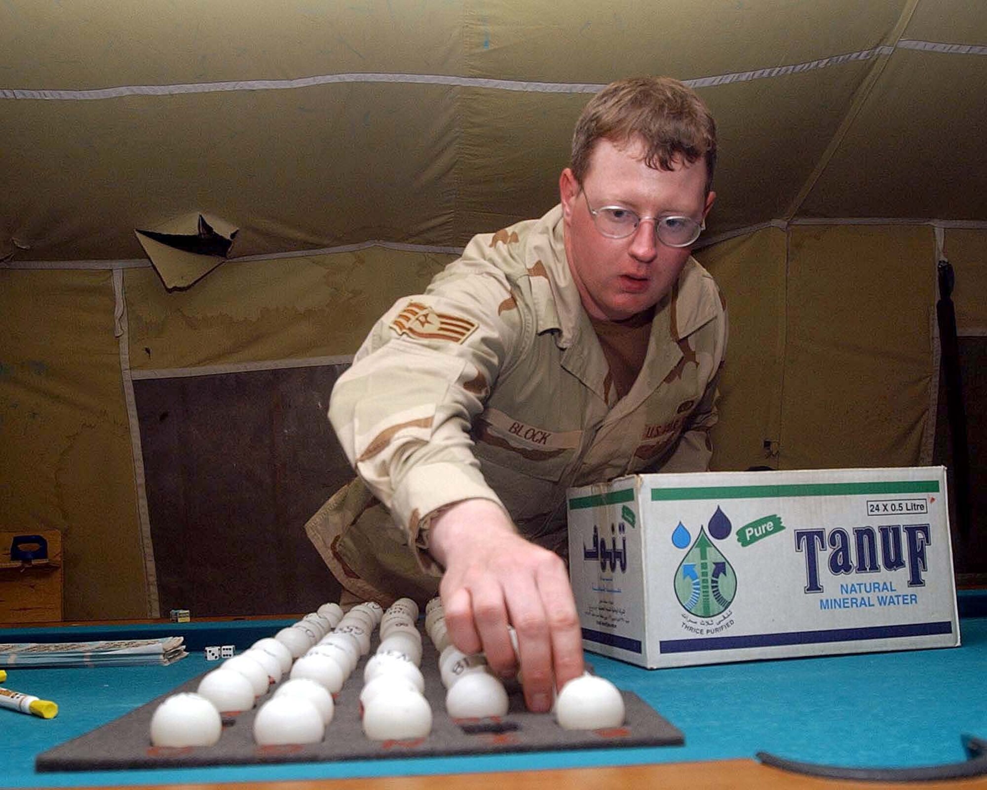BAGRAM AIR BASE, Afghanistan -- Staff Sgt. Chris Block calls out a number during a bingo game in the morale tent here Oct. 6.  Block is one of two services airmen assigned to the 455th Expeditionary Services Squadron.  (U.S. Air Force photo by Staff Sgt. Russell Wicke)