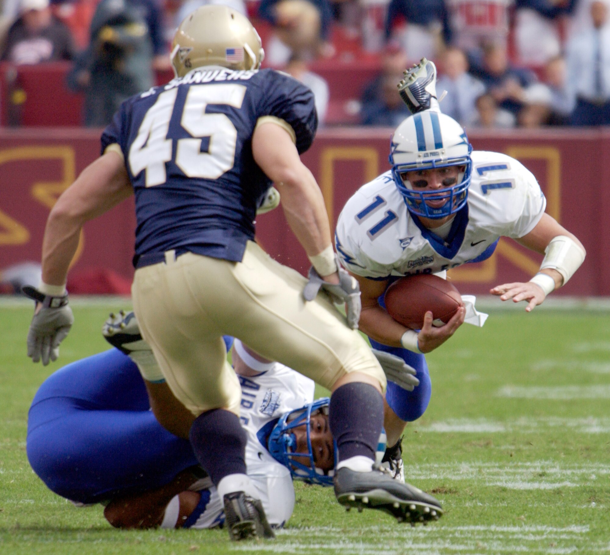 LANDOVER, Md. -- U.S. Air Force Academy quarterback Chance Harridge fights for yardage during an early drive against the U.S. Naval Academy squad at FedEx Field here Oct. 4.  Harridge carried the ball 21 times for 129 yards and despite some promising early success, the Air Force Falcon's fell to the Navy Midshipmen 28-25.  (U.S. Air Force photo by Master Sgt. Jim Varhegyi)