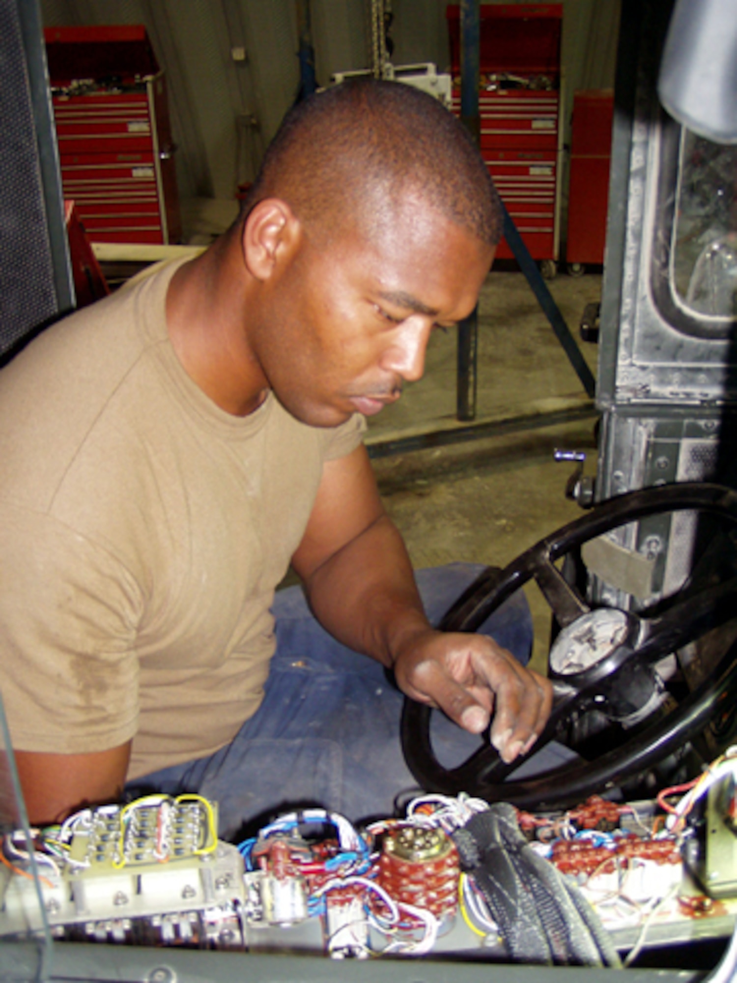 AL UDEID AIR BASE, Qatar -- Staff Sgt. Tyronne Williams troubleshoots a cab-lift circuit on an aircraft loader here Sept. 30.  The circuit enables the vehicle's front and back ends to lift together.  Williams is a special-purpose mechanic with the 379th Expeditionary Logistics Readiness Squadron here.  He is deployed from Shaw Air Force Base, S.C.  (U.S. Air Force photo by Master Sgt. William J. Sharp)