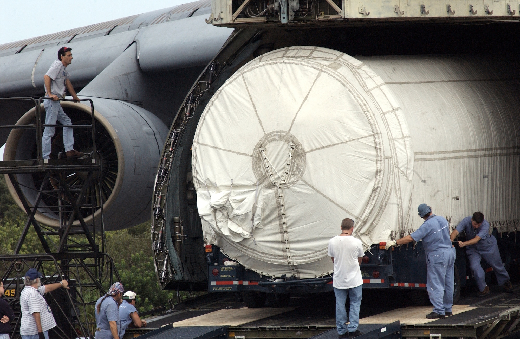 CAPE CANAVERAL AIR FORCE STATION, Fla. -- Lockheed Martin employees and airmen of the 3rd Space Launch Squadron unloaded a Titan IVB rocket from a C-5 Galaxy on Oct. 4.  The rocket will be the last to launch from here in late 2004.  (U.S. Air Force photo by 1st Lt. Warren Comer)
