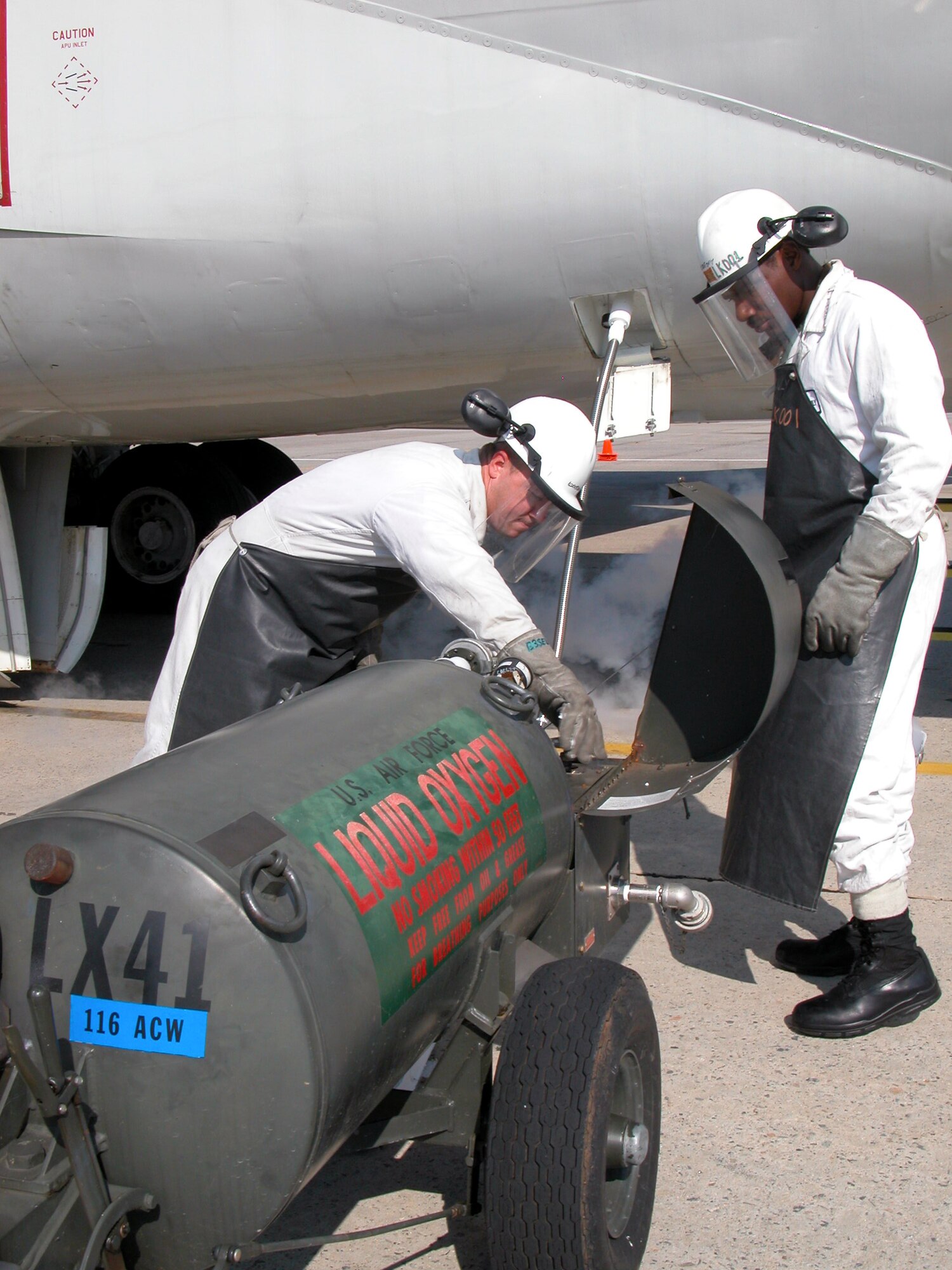 ROBINS AIR FORCE BASE, Ga. -- Staff Sgts. Brian Holliman and Dave Houghtaling fill the tank of an E8C JSTARS with liquid oxygen.  Holliman is a crew chief with the 116th Air Control Wing and Houghtaling is an Air National Guard technician.  Both make up a specialized team that ensures an aircraft has enough LOX to get it through a flight.  (U.S. Air Force photo by Sue Sapp
