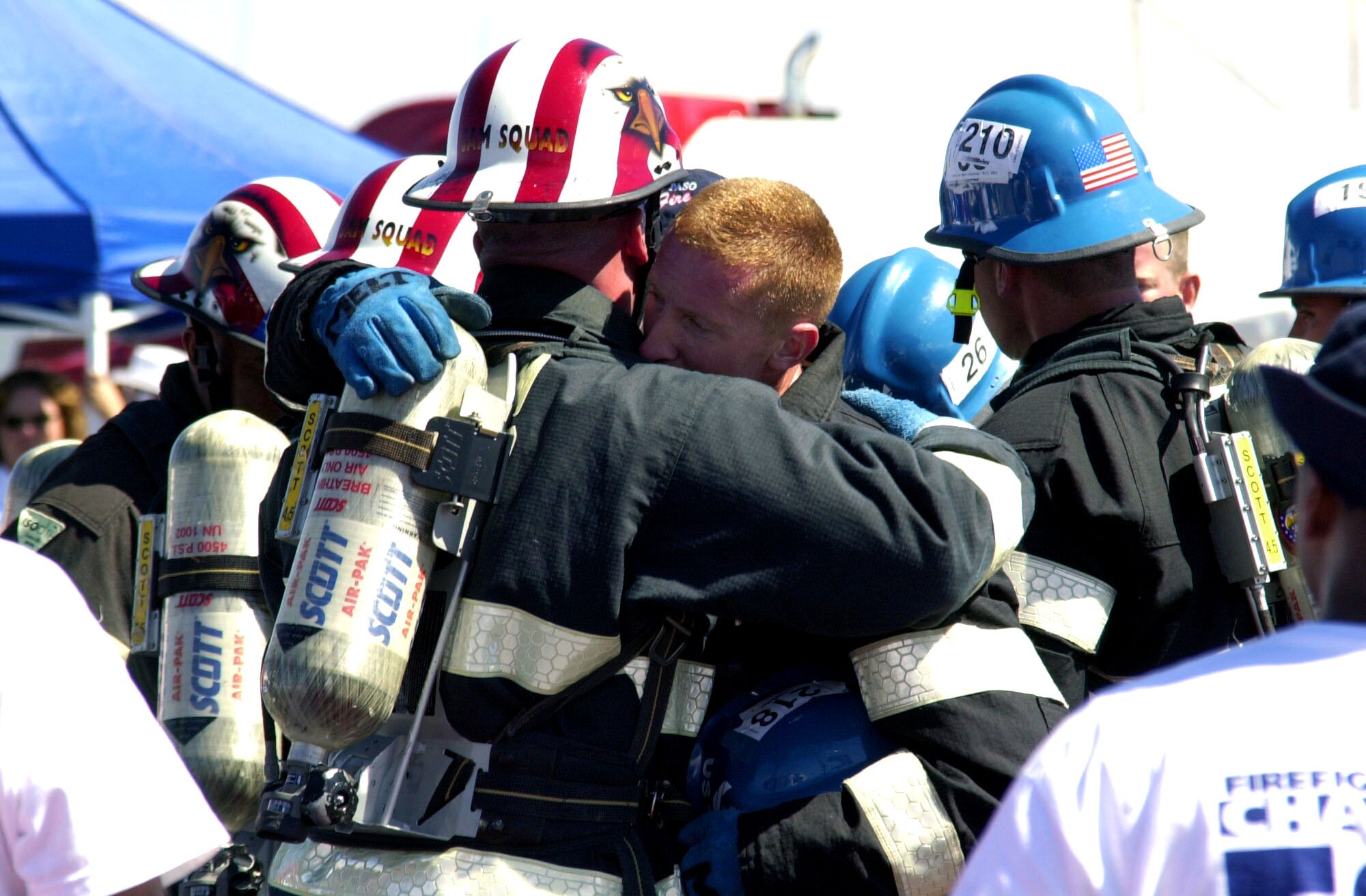 EL PASO, Texas -- Staff Sgt. Mike Melton is congratulated by a fellow firefighter after the firefighting team from Travis Air Force Base, Calif., won the relay event with the third fastest time of the 2003 firefighter combat challenge season.  Melton is the team's captain.  (U.S. Air Force photo by Senior Airman Matthew Bates)