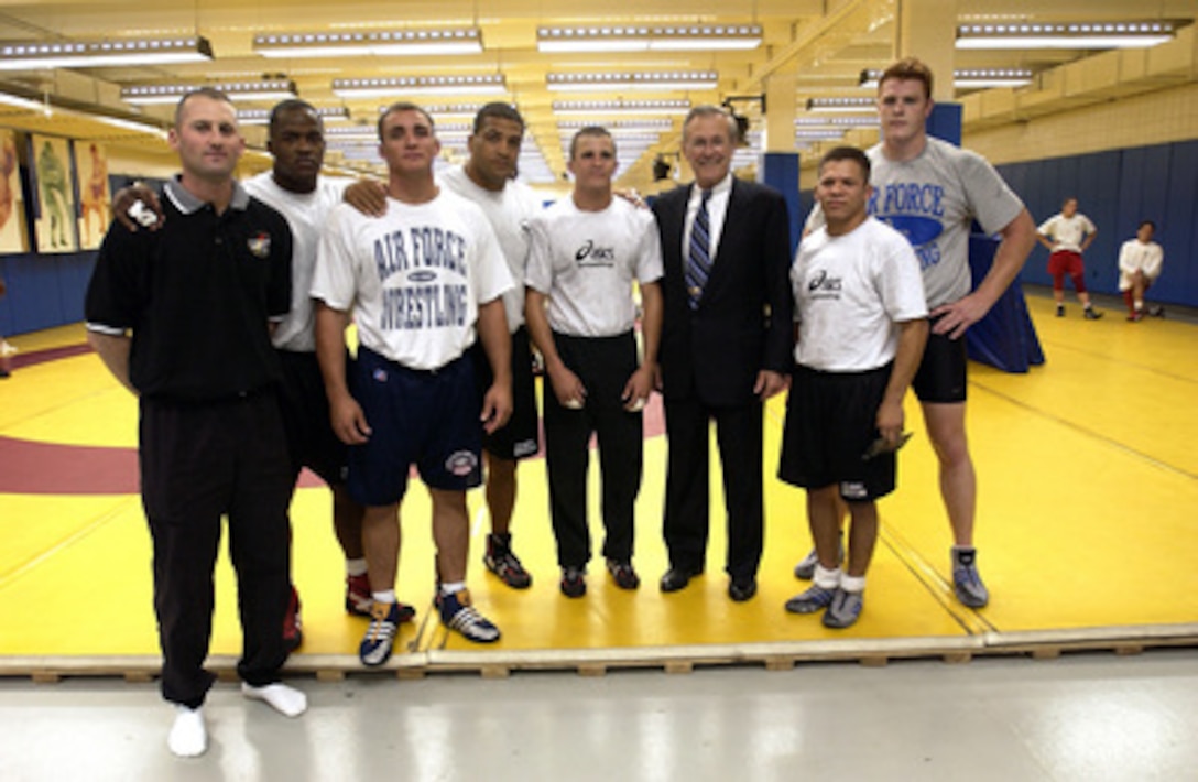 Secretary of Defense Donald H. Rumsfeld poses for a photo with military wrestlers training at the U.S. Olympic Complex in Colorado Springs, Colo., on Oct. 7, 2003. Rumsfeld, a former wrestling team captain at Princeton and an All-Navy wrestler, is visiting area commands prior to hosting the 2003 NATO informal defense ministers' meeting in Colorado Springs on October 8th and 9th. 