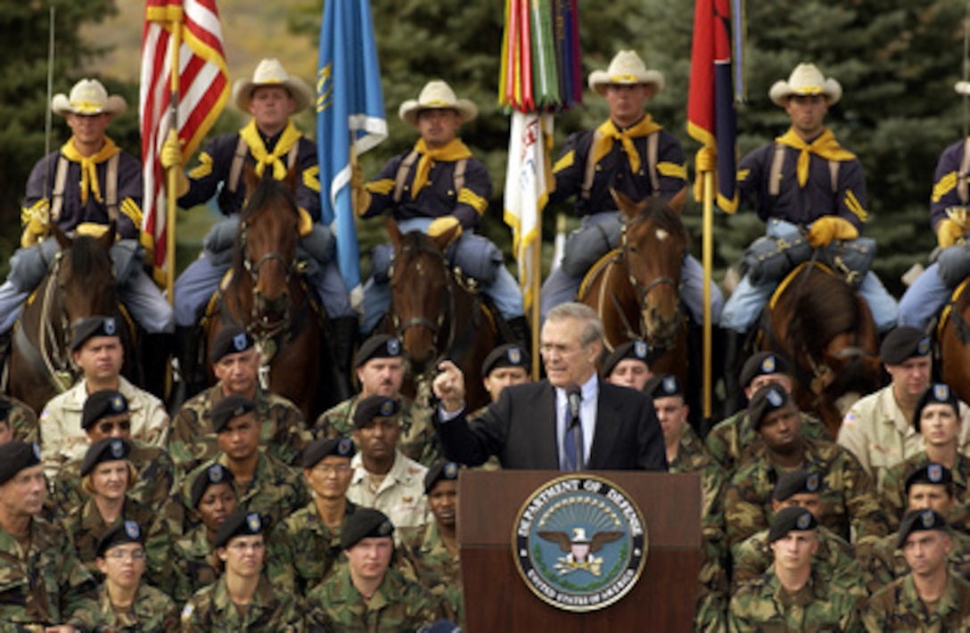 Secretary of Defense Donald H. Rumsfeld gestures to make a point as he answers a question from a member of the audience during a town hall meeting at Fort Carson, Colo., on Oct. 7, 2003. Rumsfeld delivered his opening remarks then fielded questions from military and civilian attendees. Rumsfeld is visiting area commands prior to hosting the 2003 NATO informal defense ministers' meeting in Colorado Springs on October 8th and 9th. 