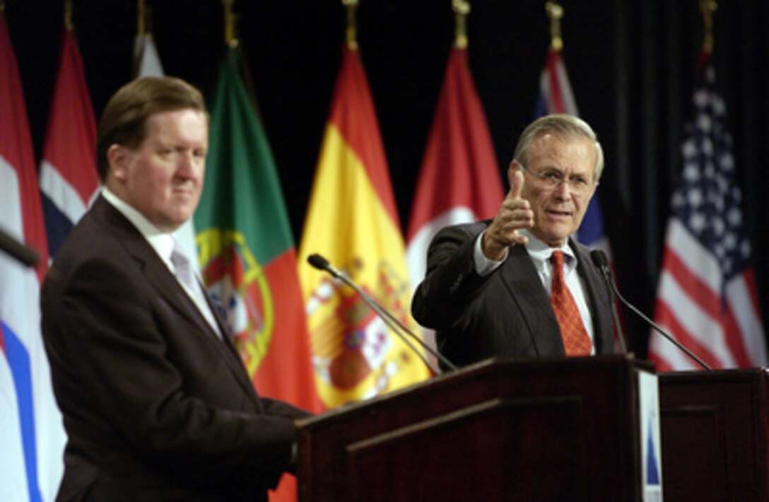 Secretary of Defense Donald H. Rumsfeld (right) answers questions from members of the media during a joint news conference with NATO Secretary General Lord George Robertson in Colorado Springs, Colo., on Oct. 8, 2003. Rumsfeld and Robertson met with the international press after a meeting of NATO Defense Ministers. Rumsfeld is the host for the informal meetings on October 8th and 9th. 