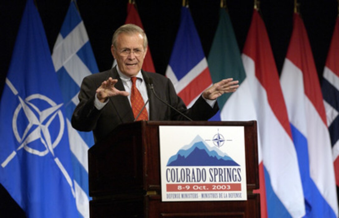 Secretary of Defense Donald H. Rumsfeld answers questions from members of the media during a joint news conference with NATO Secretary General Lord George Robertson in Colorado Springs, Colo., on Oct. 8, 2003. Rumsfeld and Robertson met with the international press after a meeting of NATO Defense Ministers. Rumsfeld is the host for the informal meetings on October 8th and 9th. 