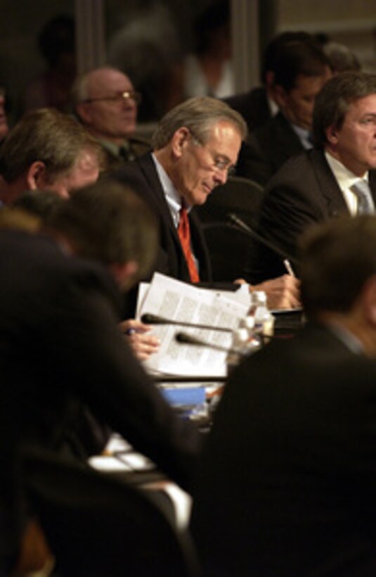 Secretary of Defense Donald H. Rumsfeld takes notes during a round table discussion of NATO Defense Ministers in Colorado Springs, Colo., on Oct. 8, 2003. Rumsfeld is the host for the informal meetings on October 8th and 9th. 