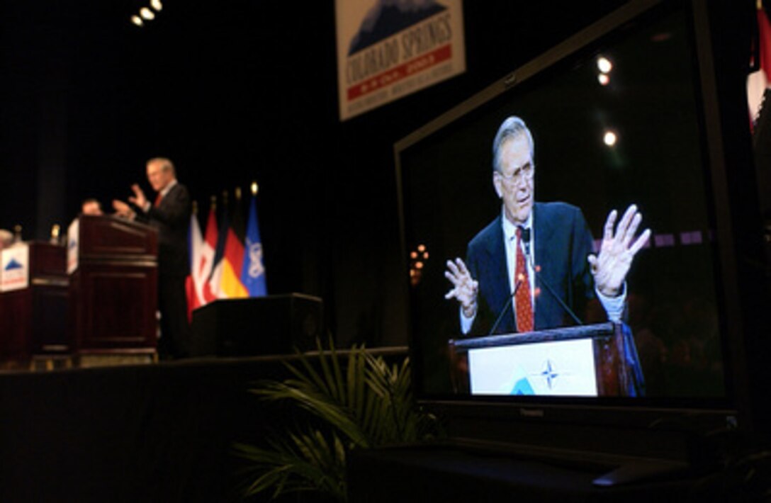 A television monitor relays the image of Secretary of Defense Donald H. Rumsfeld as he answers questions from members of the media during a joint news conference with NATO Secretary General Lord George Robertson in Colorado Springs, Colo., on Oct. 8, 2003. Rumsfeld and Robertson met with the international press after a meeting of NATO Defense Ministers. Rumsfeld is the host for the informal meetings on October 8th and 9th. 